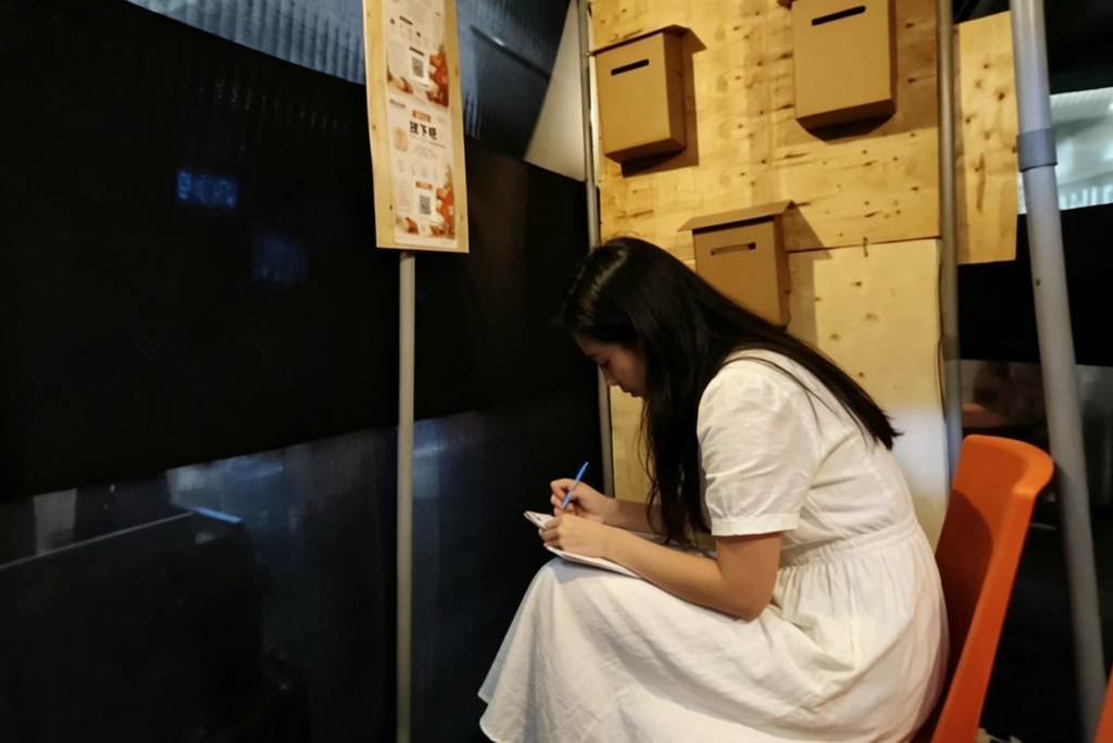 visitor go through urban emotion experience, let go section, writing letter 